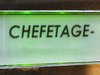 Eine Klingel mit leicht grünem Hintergrund und de, Wort Chefetage.